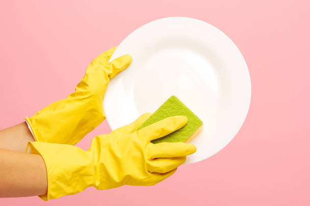 Hands in yellow protective gloves washing a plate - Fotografie, Obrázek