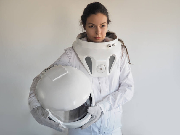 Female astronaut on a white background. Fantastic space suit. Exploration of outer space. - Foto, imagen