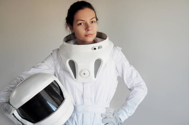 Female astronaut on a white background. Fantastic space suit. Exploration of outer space. - Fotografie, Obrázek