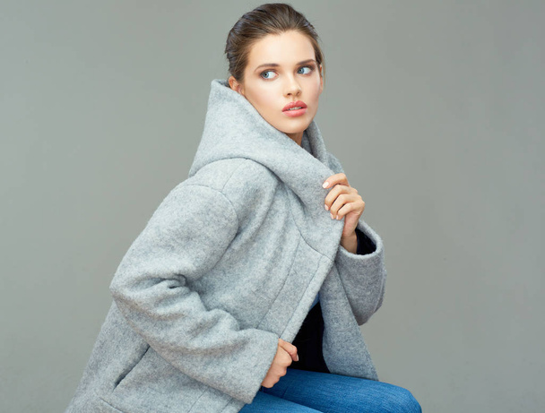 Young woman wearing coat with big hood looking back.  - Fotografie, Obrázek