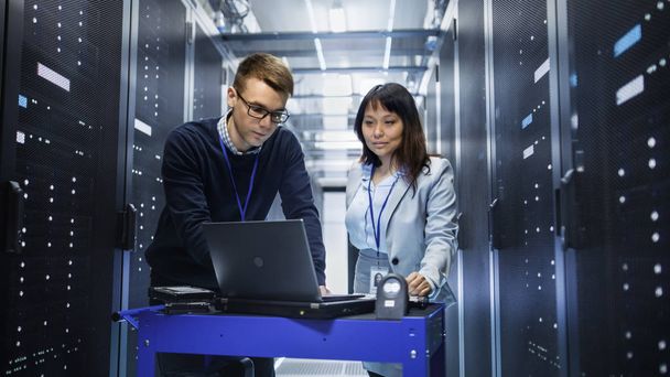 Caucasian Male and Asian Female IT Technicians Working with Comp - Foto, Bild