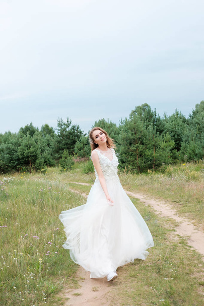 young pretty woman (bride) in white wedding dress outdoors, make - Foto, Imagen