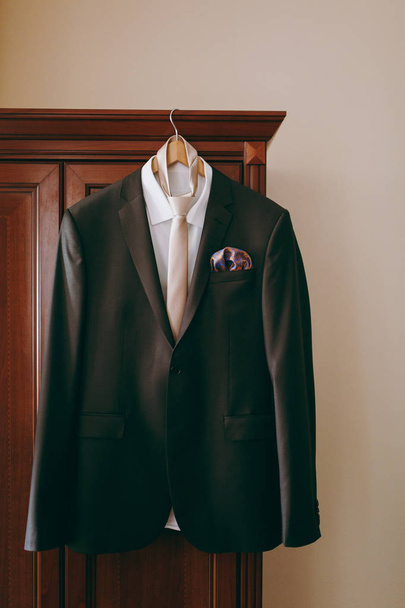 A suit of the groom hanging in the room - Photo, image