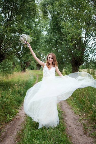 portrait of young pretty woman (bride) in white wedding dress ou - Foto, Imagen