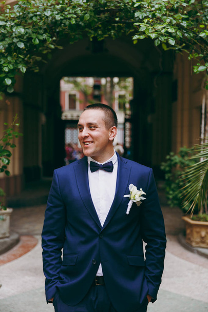 Groom in a suit and a bow tie for a walk - Fotoğraf, Görsel