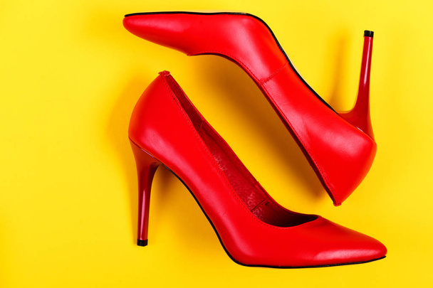 Pair of elegant female shoes in red colour - 写真・画像