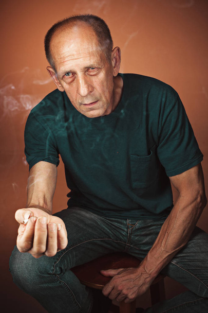 Worried mature man sitting at studio - Valokuva, kuva