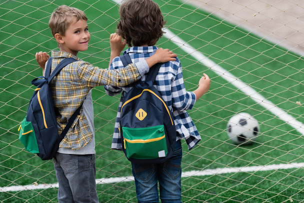 schoolboys on soccer field  - Фото, изображение