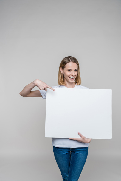 woman pointing at blank board - Foto, Imagen