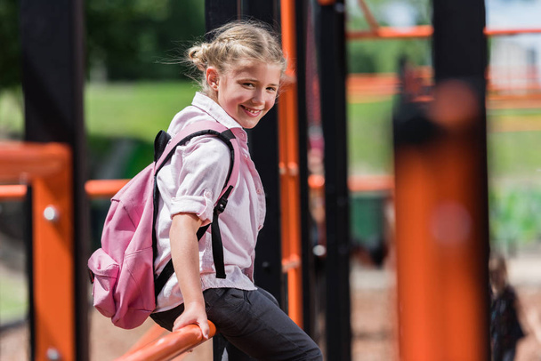 schoolchild with backpack on playground - Foto, Imagem