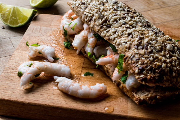 Shrimp Sandwich with lime on wooden surface. - Photo, Image
