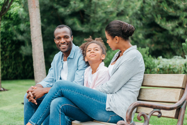 african american family resting on bench - Photo, Image