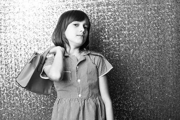 small pretty smiling girl with fashionable red leather bag - 写真・画像