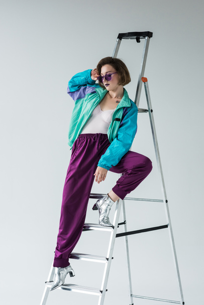 stylish woman leaning on ladder - Фото, зображення