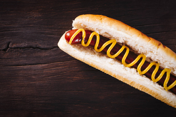 Tasty hot dogs on wooden background - Fotografie, Obrázek