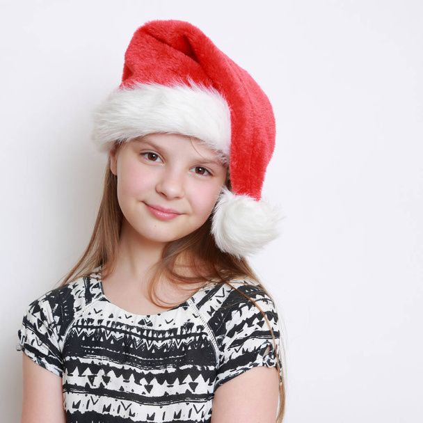 little girl in santa hat  - Фото, изображение