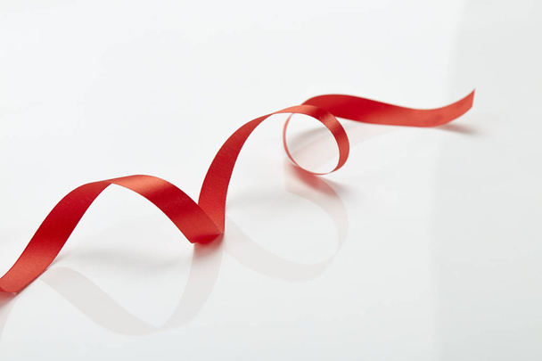 Red curly ribbon isolated on white - Фото, изображение