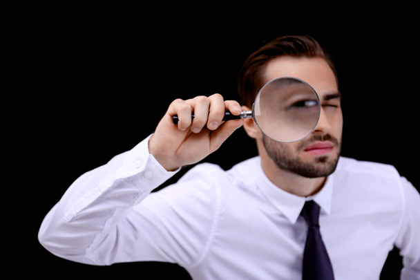 Handsome young man with magnifier - Foto, Imagen