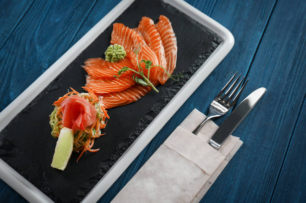 Delicious salmon fillet on slate plate - Φωτογραφία, εικόνα