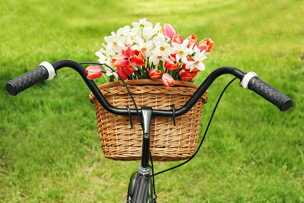 Bicycle with basket of beautiful flowers  - Fotó, kép