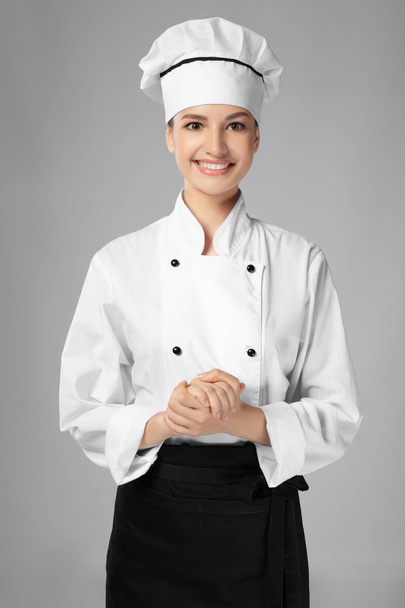 Young female chef on light background - Фото, зображення