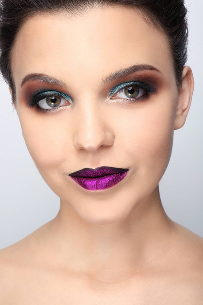 Beautiful young woman with creative makeup on light background, closeup - Fotoğraf, Görsel