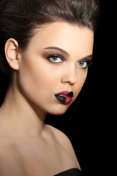 Beautiful young woman with creative makeup on dark background, closeup - Fotoğraf, Görsel