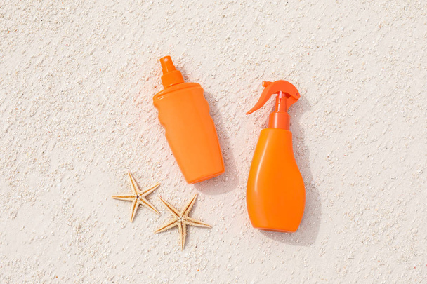 Bottles with sunscreen cream and starfish - Fotó, kép