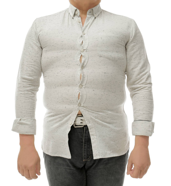 Diet concept. Overweight man in tight shirt on white background - Foto, afbeelding