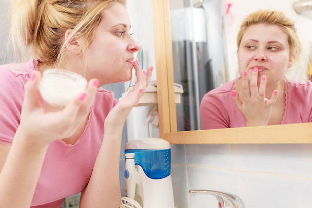 Woman applying face cream with her finger - Фото, зображення