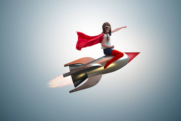 Süper kahraman kavramında küçük bir kız roket uçuruyor. - Fotoğraf, Görsel