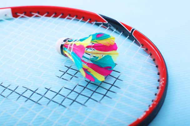 Close-up of badmington rackets with balls on a blue background - Fotoğraf, Görsel