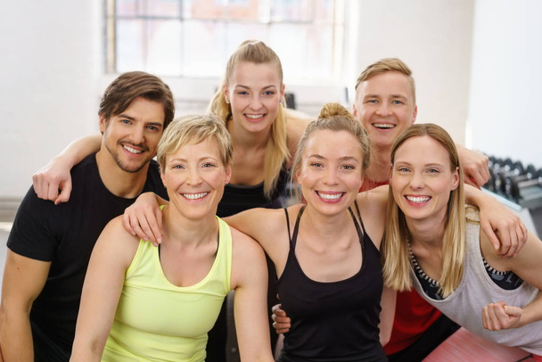Group portrait of cheerful people at gym - Fotó, kép