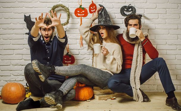 Halloween friends surprised drinking tea and celebrating - 写真・画像