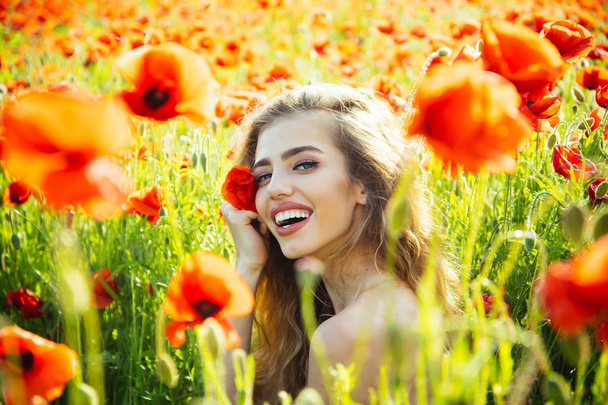 beautiful woman on poppy field with long hair - Fotó, kép