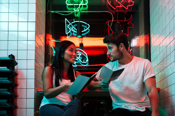 Multiethnic happy loving couple sitting in cafe - Zdjęcie, obraz