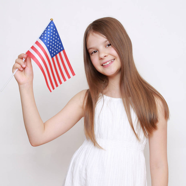 little girl holding USA flag in studio - Fotoğraf, Görsel