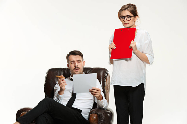 The young man and beautiful woman in business suit at office on white background - Foto, imagen