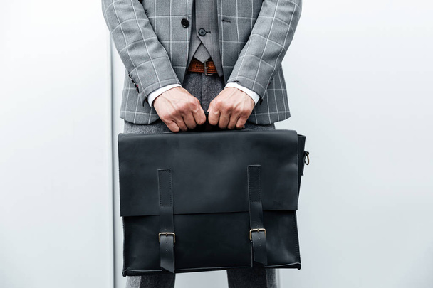 Close up of a man in suit holding briefcase - Foto, imagen