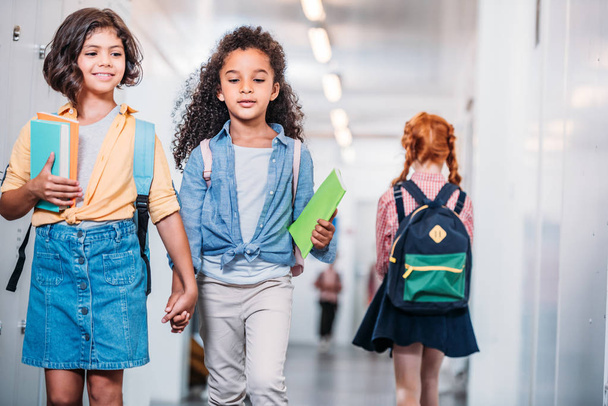 girls walking through school corridor - Valokuva, kuva