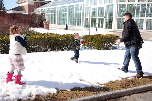 young child throws snow at his father  - Photo, Image