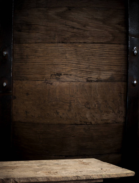 background of barrel and worn old table of wood - Фото, изображение