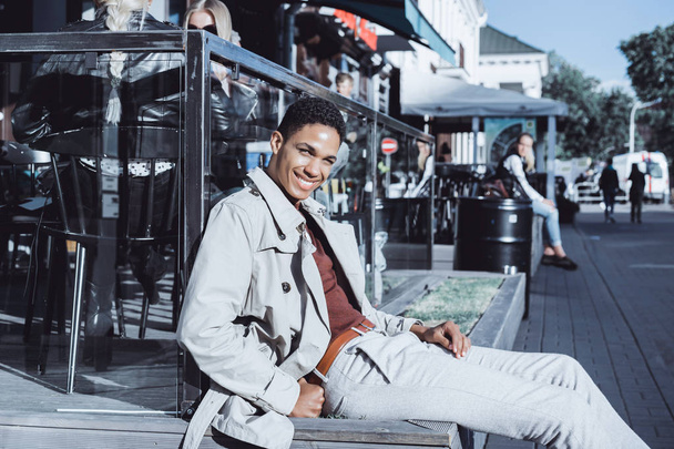 man in coat posing in street cafe - Foto, Bild