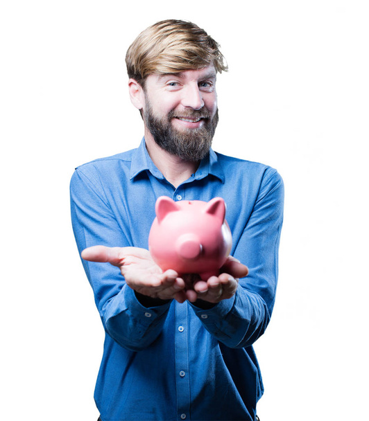 young blonde man with a piggybank - Foto, immagini