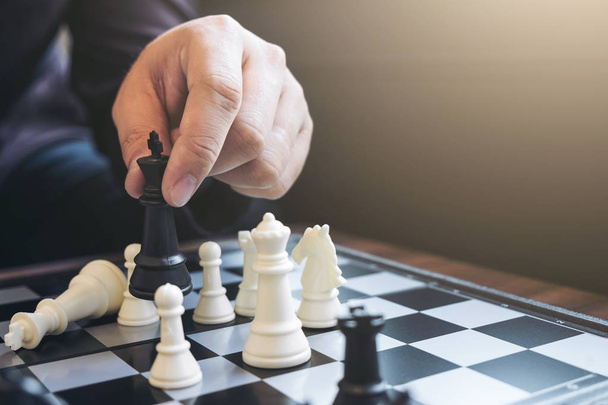 Close up of hands confident businessman colleagues playing chess - Photo, Image