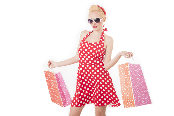 Retro pin up girl shopping. Woman holding paper bag - Fotó, kép