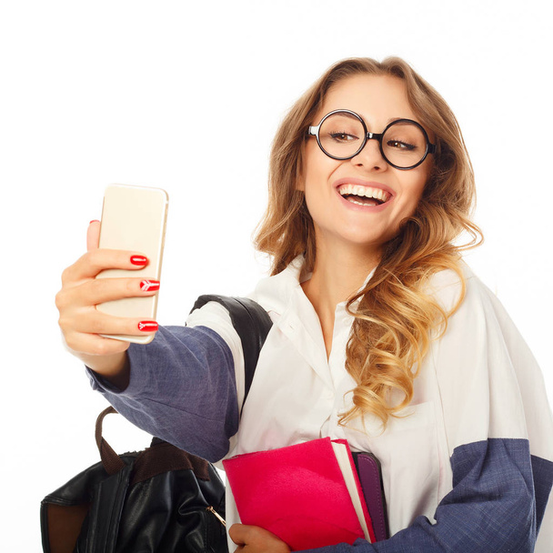 Portrait of a beautiful young woman making selfie on smart phone - Foto, Bild