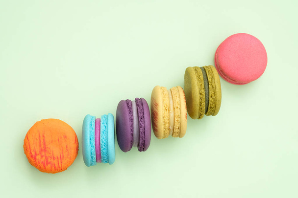 colorful macaroons on green background. - Photo, Image