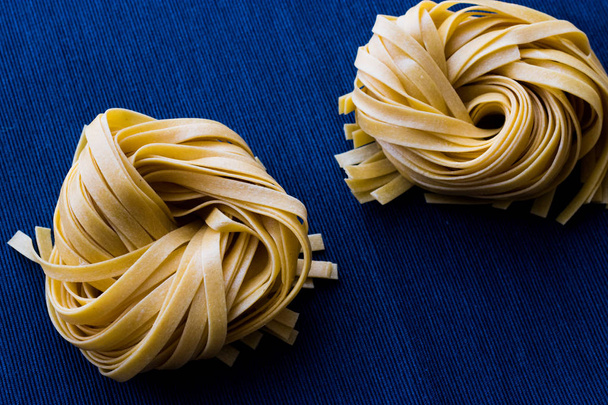 Raw Tagliatelle / Uncooked Pasta or Spaghetti - Fotoğraf, Görsel