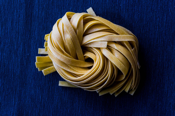 Raw Tagliatelle / Uncooked Pasta or Spaghetti - Fotoğraf, Görsel